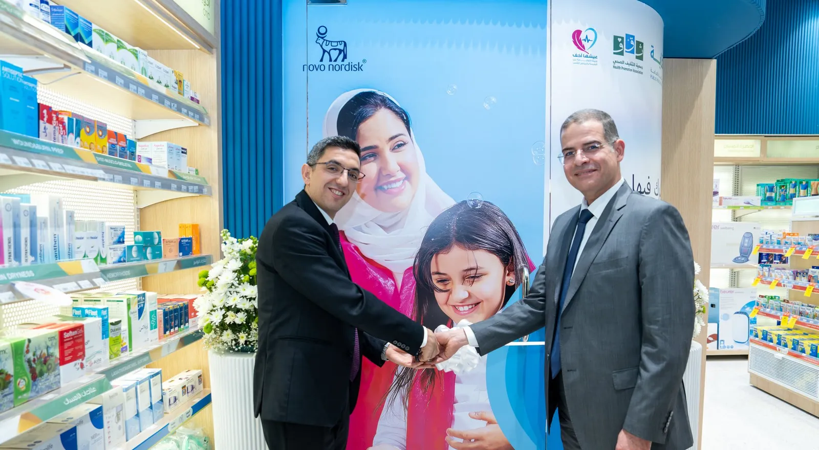 Executives cut the ribbon at clinic door before campaign graphic