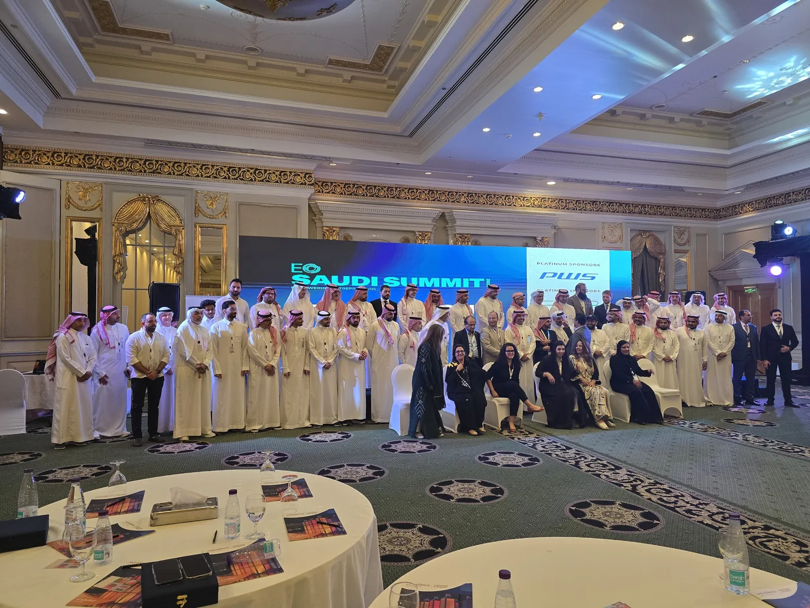 Full attendee group photo in front of EO Saudi Summit LED wall