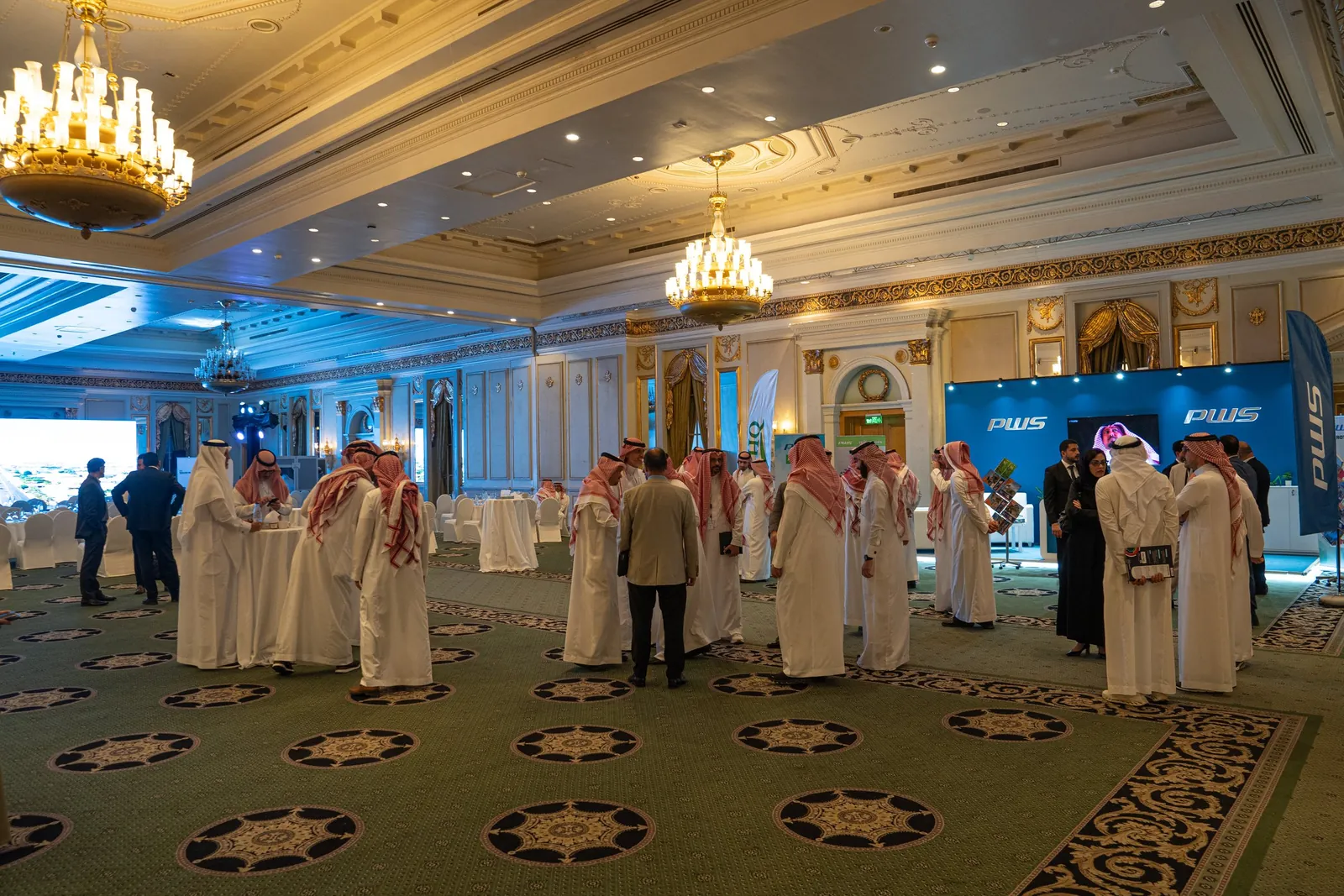 Networking guests in ballroom near PWS booth