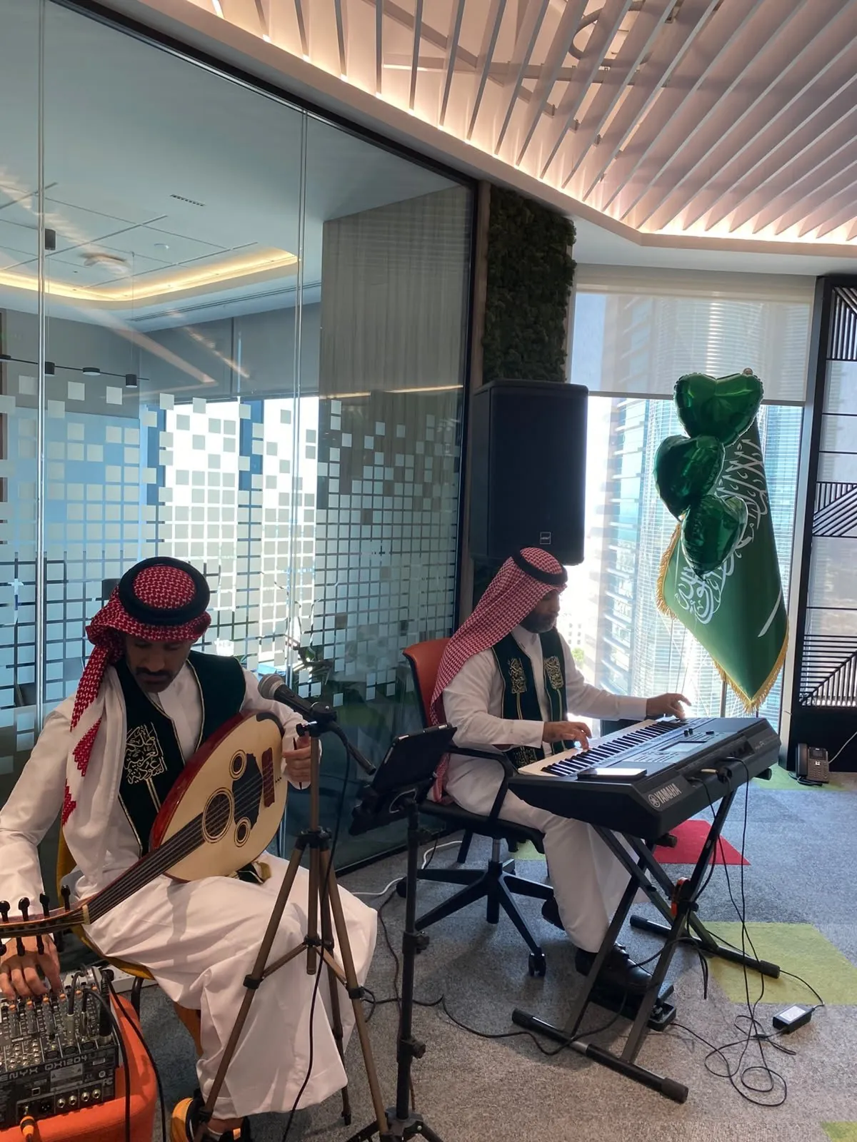 Oud player and keyboardist performing in the PwC office