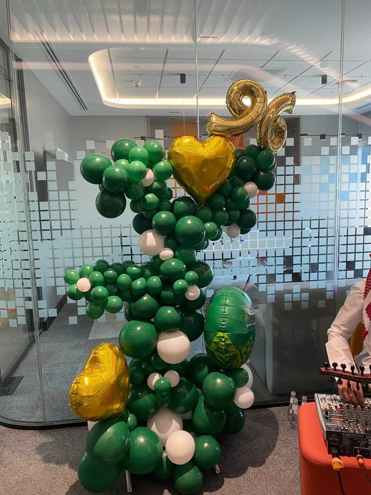 PwC green balloon sculpture with gold 96 and heart