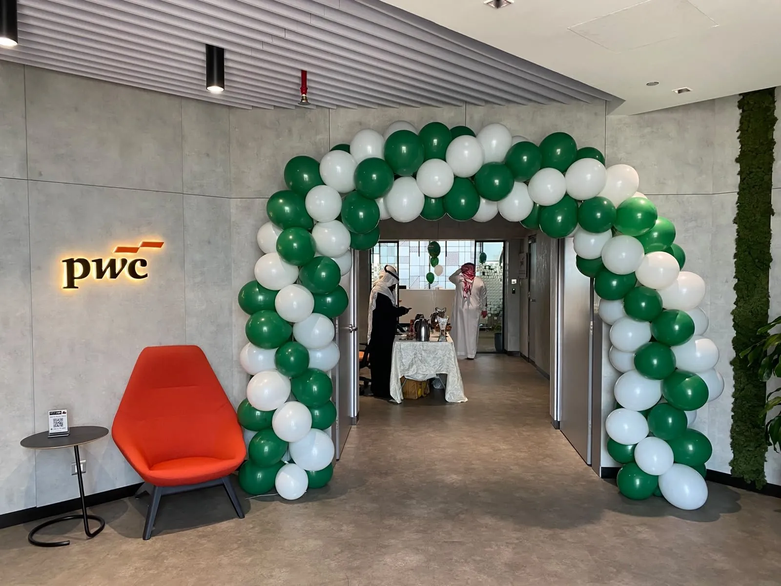 Balloon arch framing the PwC entrance