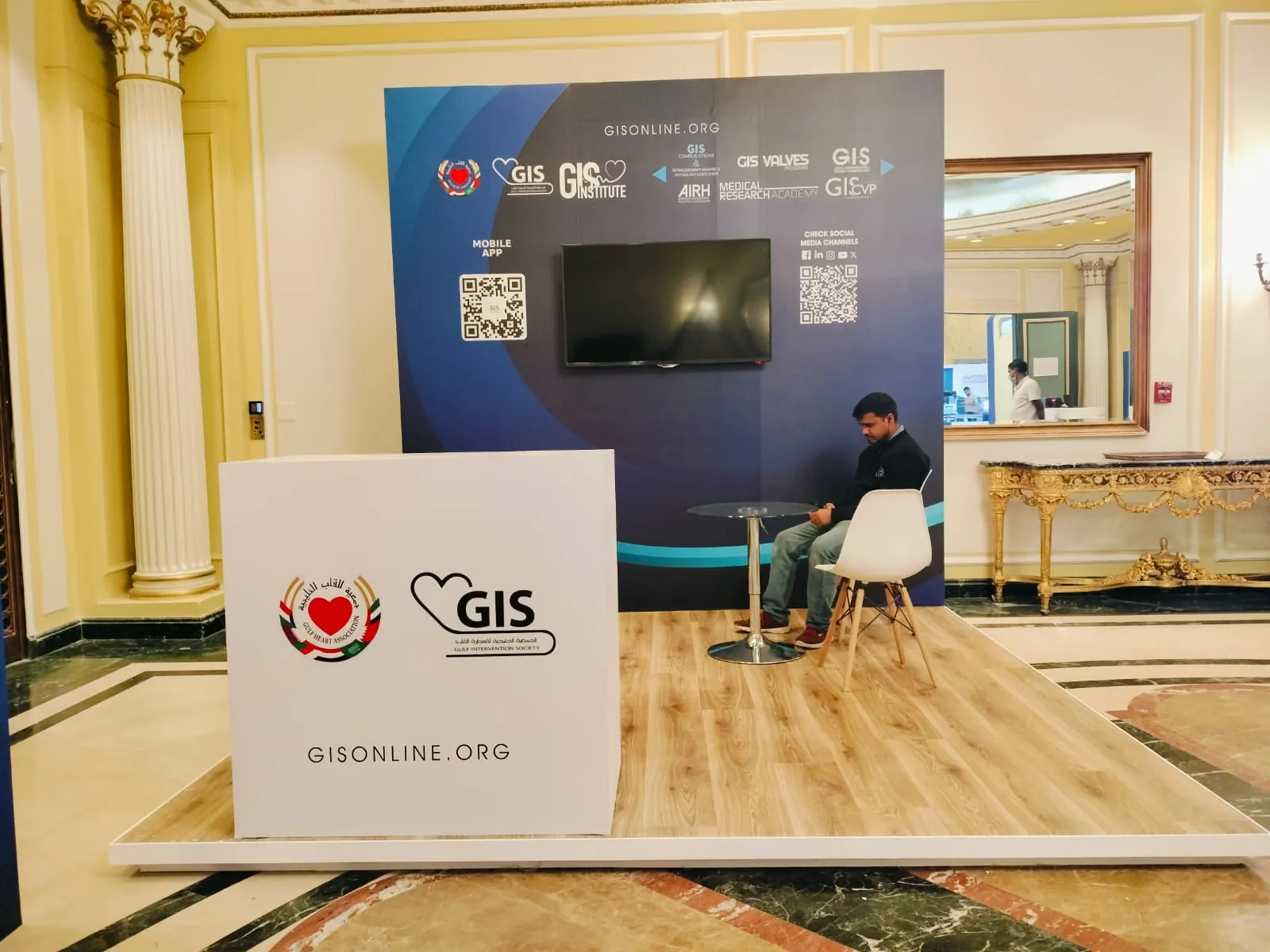 Modular exhibition booth with printed backdrop, screen, branded counter, and timber-effect flooring